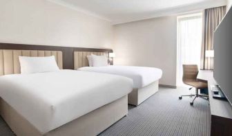 Double guest room with TV screen and desk at the Hilton London Gatwick Airport.