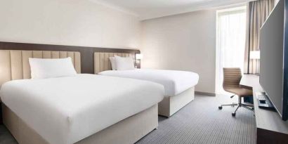 Double guest room with TV screen and desk at the Hilton London Gatwick Airport.