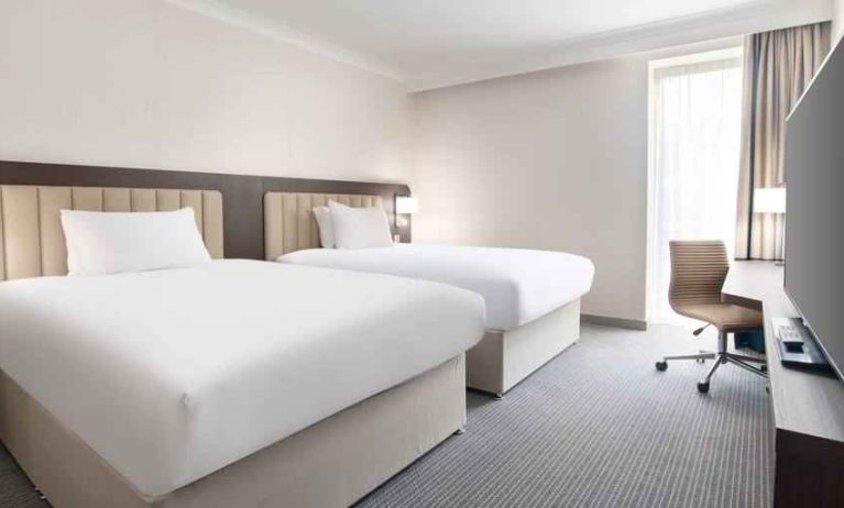 Double guest room with TV screen and desk at the Hilton London Gatwick Airport.