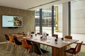 Bright living room with wooden table at the The Westminster London, Curio Collection by Hilton.