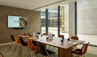 Bright living room with wooden table at the The Westminster London, Curio Collection by Hilton.