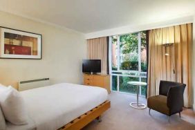 Hotel room with desk overlooking the garden at the Hilton Northampton.