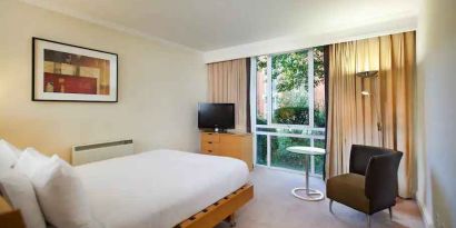 Hotel room with desk overlooking the garden at the Hilton Northampton.