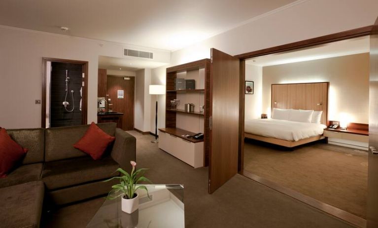 Deluxe suite with king size bed and sofa at the Hilton London Heathrow Airport Terminal 5.