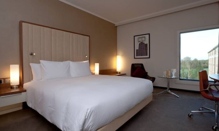 King bedroom with window at the Hilton London Heathrow Airport Terminal 5.