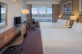 Double bedroom with sofa and desk at the DoubleTree by Hilton London - Chelsea.