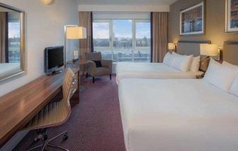 Double bedroom with sofa and desk at the DoubleTree by Hilton London - Chelsea.