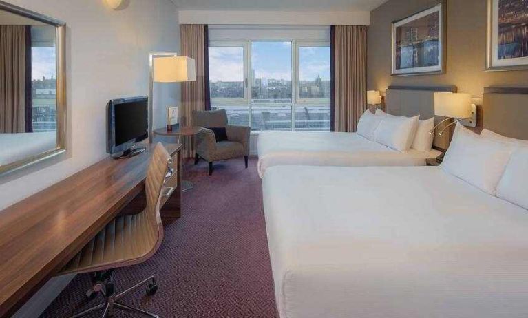 Double bedroom with sofa and desk at the DoubleTree by Hilton London - Chelsea.