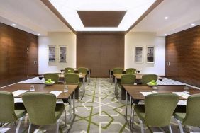 Large coworking or conference meeting room with six tables of four seats each,