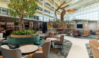 Beautiful hotel patio with plants perfect as workspace at the Hilton London Heathrow Airport.