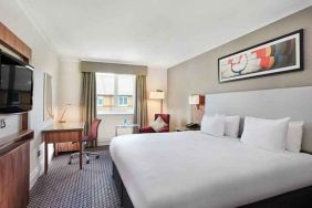 King bedroom with TV screen and desk at the DoubleTree by Hilton Bristol North.