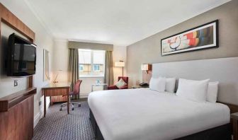 King bedroom with TV screen and desk at the DoubleTree by Hilton Bristol North.