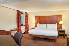 King size bed, seating area and desk in a guestroom at the DoubleTree by Hilton Southampton.