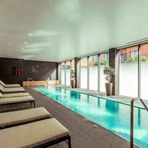 Relaxing indoor pool at the Fellows House Cambridge, Curio Collection by Hilton.