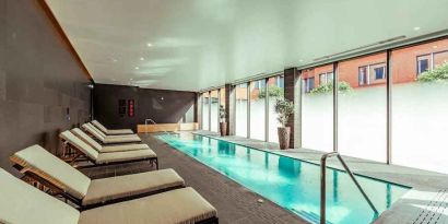 Relaxing indoor pool at the Fellows House Cambridge, Curio Collection by Hilton.