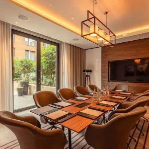 Small meeting room with TV screen at the Fellows House Cambridge, Curio Collection by Hilton.