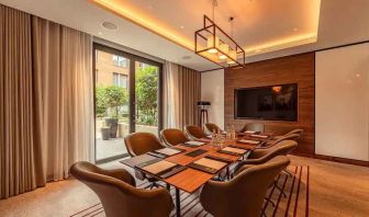 Small meeting room with TV screen at the Fellows House Cambridge, Curio Collection by Hilton.