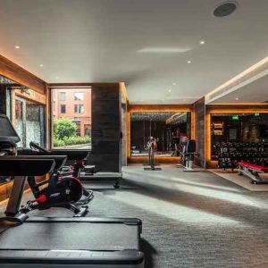 Fully equipped fitness center at the Fellows House Cambridge, Curio Collection by Hilton.