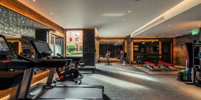 Fully equipped fitness center at the Fellows House Cambridge, Curio Collection by Hilton.