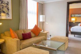 Hotel suite with living room and bedroom at the Hilton London Kensington.