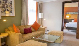 Hotel suite with living room and bedroom at the Hilton London Kensington.