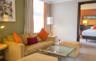 Hotel suite with living room and bedroom at the Hilton London Kensington.