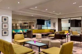 Lobby workspace with tables and chairs at the Hilton London Kensington.