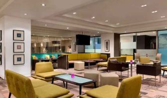 Lobby workspace with tables and chairs at the Hilton London Kensington.