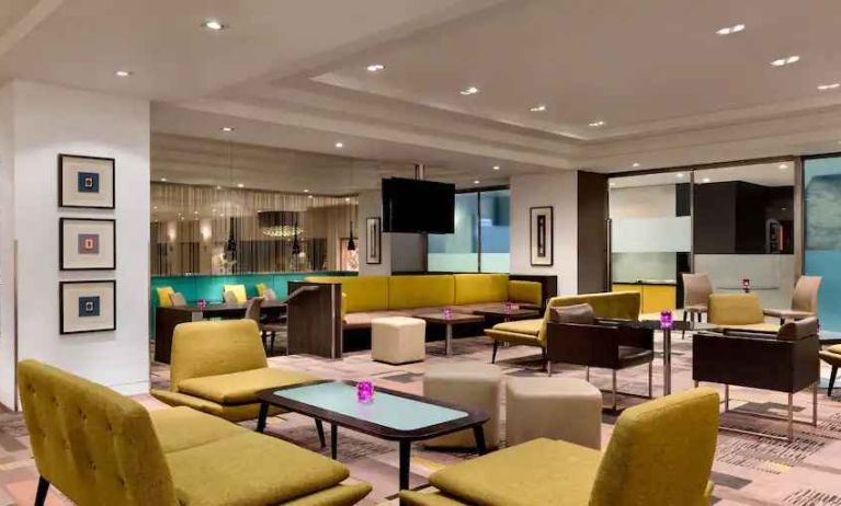 Lobby workspace with tables and chairs at the Hilton London Kensington.