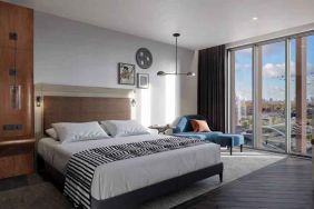 Bright king bedroom with view at the Gantry London, Curio Collection by Hilton.