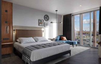 Bright king bedroom with view at the Gantry London, Curio Collection by Hilton.