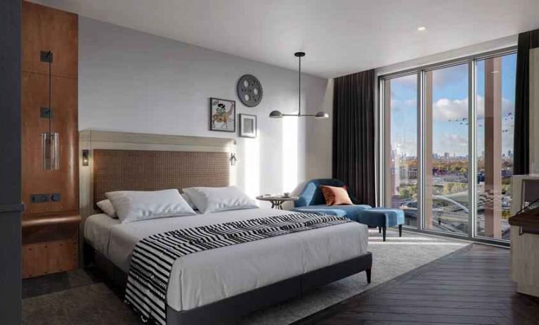 Bright king bedroom with view at the Gantry London, Curio Collection by Hilton.