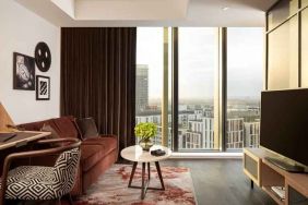 Comfortable living room with working station at the Gantry London, Curio Collection by Hilton.