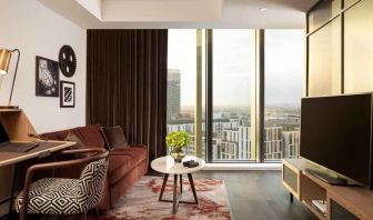 Comfortable living room with working station at the Gantry London, Curio Collection by Hilton.