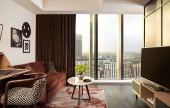 Comfortable living room with working station at the Gantry London, Curio Collection by Hilton.