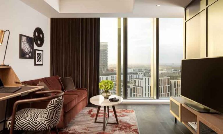 Comfortable living room with working station at the Gantry London, Curio Collection by Hilton.