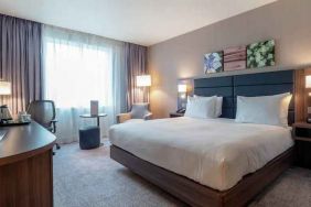 King bedroom with desk and TV screen at the Hilton Garden Inn Birmingham Airport UK.