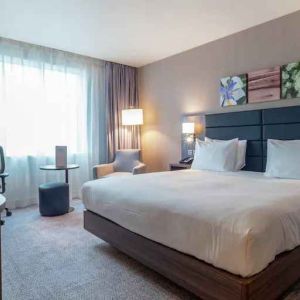 King bedroom with desk and TV screen at the Hilton Garden Inn Birmingham Airport UK.