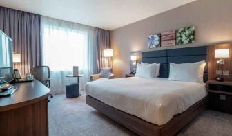 King bedroom with desk and TV screen at the Hilton Garden Inn Birmingham Airport UK.