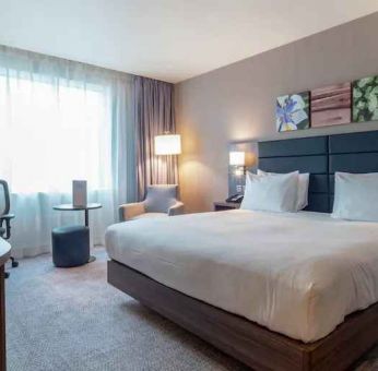 King bedroom with desk and TV screen at the Hilton Garden Inn Birmingham Airport UK.