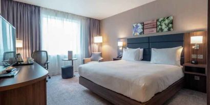 King bedroom with desk and TV screen at the Hilton Garden Inn Birmingham Airport UK.