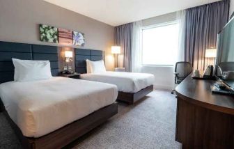 Comfortable twin room with working station at the Hilton Garden Inn Birmingham Airport UK.