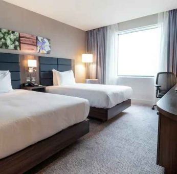 Comfortable twin room with working station at the Hilton Garden Inn Birmingham Airport UK.