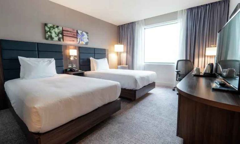 Comfortable twin room with working station at the Hilton Garden Inn Birmingham Airport UK.