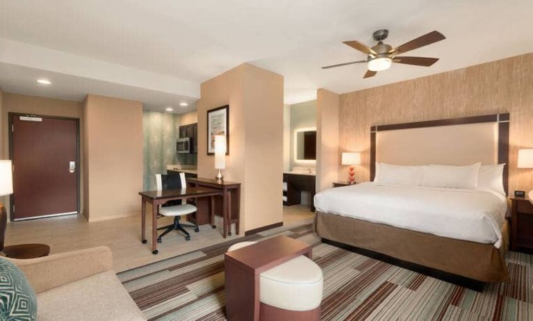 Open layout king size suite with king bed, tv, and kitchenette at the Homewood Suite by Hilton Atlanta Perimeter.