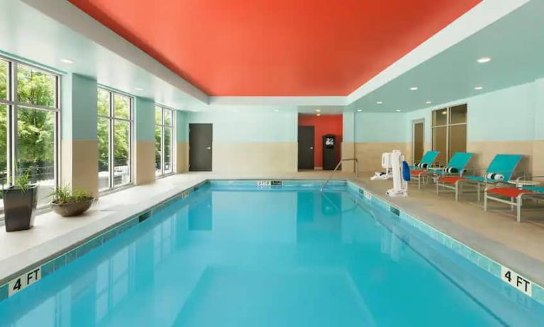 Indoor pool with pool chairs at the Homewood Suite by Hilton Atlanta Perimeter.