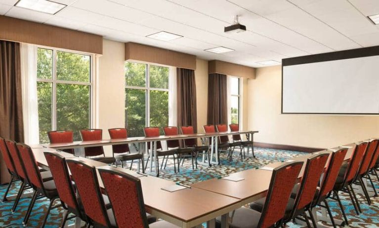 Meeting room with projector board for board meetings at the Homewood Suite by Hilton Atlanta Perimeter.