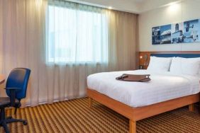 Hotel bedroom with desk at the Hampton by Hilton London Luton Airport.