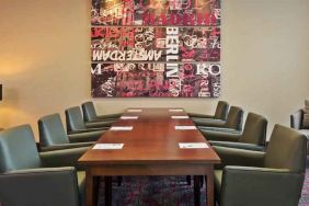 Meeting room with comfortable chairs at the Hampton by Hilton London Luton Airport.