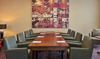 Meeting room with comfortable chairs at the Hampton by Hilton London Luton Airport.